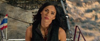 Movie still from “Expend4bles” (2023), directed by Scott Waugh – A beautiful woman with long black curly hair; Close Up shot, Over the shoulder angle