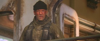 Movie still from “Expend4bles” (2023), directed by Scott Waugh – A person wearing a hat; Close Up shot, Low angle