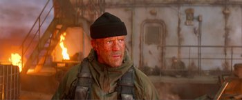 Movie still from “Expend4bles” (2023), directed by Scott Waugh – A person wearing a hat and jacket; Close Up shot, Low angle