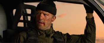 Movie still from “Expend4bles” (2023), directed by Scott Waugh – A person in a vehicle; Close Up shot, Low angle