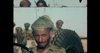 Movie still from “Explorer” (2022), directed by Matthew Dyas – A group of men standing next to each other; Close Up shot, High angle