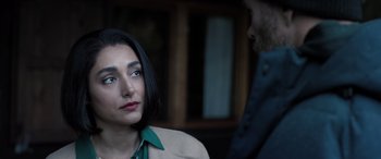 Movie still from “Extraction II” (2023), directed by Sam Hargrave – A woman is looking at a man in a green shirt; Close Up shot, Over the shoulder angle