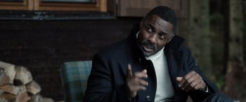 Movie still from “Extraction II” (2023), directed by Sam Hargrave – A man in a black jacket is talking to someone; Close Up shot, Over the shoulder angle