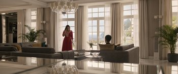 Movie still from “Extraction II” (2023), directed by Sam Hargrave – A woman standing in front of a mirror in a living room; Wide shot, Low angle