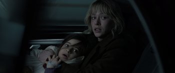 Movie still from “Extraction II” (2023), directed by Sam Hargrave – Two people sitting in a car looking at the camera; Close Up shot, Low angle
