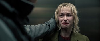 Movie still from “Extraction II” (2023), directed by Sam Hargrave – A woman with her hand on her head; Close Up shot, Over the shoulder angle