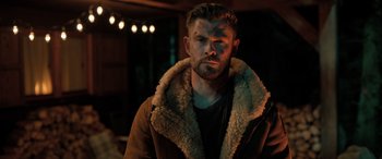 Movie still from “Extraction II” (2023), directed by Sam Hargrave – A person wearing a jacket; Medium shot, Over the shoulder angle