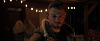 Movie still from “Extraction II” (2023), directed by Sam Hargrave – A person wearing a jacket; Close Up shot, Over the shoulder angle