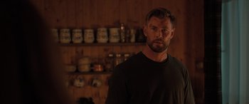 Movie still from “Extraction II” (2023), directed by Sam Hargrave – A person standing in a room; Medium shot, Over the shoulder angle