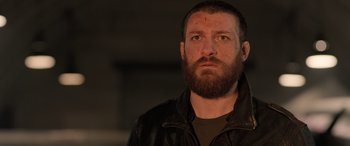 Movie still from “Extraction II” (2023), directed by Sam Hargrave – A person with a beard; Close Up shot, Low angle