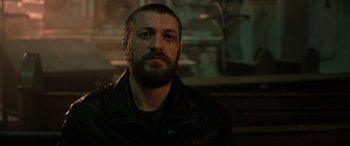 Movie still from “Extraction II” (2023), directed by Sam Hargrave – A man in a leather jacket looking at the camera; Close Up shot, Low angle