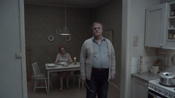A man standing in front of a woman in a room