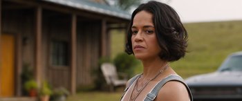 Movie still from “F9: The Fast Saga” (2021), directed by Justin Lin – A person with short black hair; Close Up shot, Over the shoulder angle