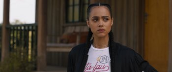 Movie still from “F9: The Fast Saga” (2021), directed by Justin Lin – A young woman wearing a t - shirt and a black jacket; Close Up shot, Over the shoulder angle