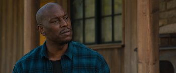 Movie still from “F9: The Fast Saga” (2021), directed by Justin Lin – A man in a plaid shirt looking up at the sky; Close Up shot, Over the shoulder angle