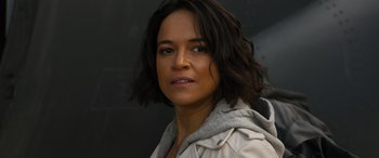 Movie still from “F9: The Fast Saga” (2021), directed by Justin Lin – A person wearing a jacket; Close Up shot, Over the shoulder angle