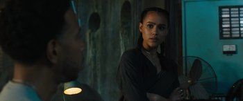 Movie still from “F9: The Fast Saga” (2021), directed by Justin Lin – A woman standing next to a man in a dark room; Close Up shot, Over the shoulder angle