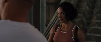 Movie still from “F9: The Fast Saga” (2021), directed by Justin Lin – A woman standing in front of a man; Close Up shot, Over the shoulder angle