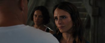 Movie still from “F9: The Fast Saga” (2021), directed by Justin Lin – Two women are standing in a room looking at the camera; Close Up shot, Over the shoulder angle