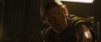 Movie still from “F9: The Fast Saga” (2021), directed by Justin Lin – A person wearing a hat; Close Up shot, Low angle