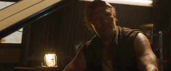 Movie still from “F9: The Fast Saga” (2021), directed by Justin Lin – A person wearing a hat; Close Up shot, Low angle