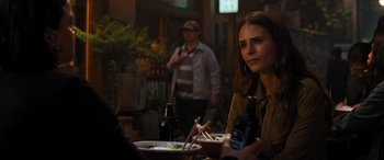 Movie still from “F9: The Fast Saga” (2021), directed by Justin Lin – A woman sitting at a table with a bowl of food; Close Up shot, Over the shoulder angle