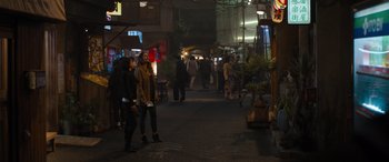 Movie still from “F9: The Fast Saga” (2021), directed by Justin Lin – A group of people walking down a street at night; Extreme Wide shot, Over the shoulder angle