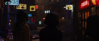 Movie still from “F9: The Fast Saga” (2021), directed by Justin Lin – A woman standing in the dark in front of a building; Wide shot, Over the shoulder angle