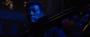 Movie still from “F9: The Fast Saga” (2021), directed by Justin Lin – A man holding a violin in a dark room; Close Up shot, Low angle