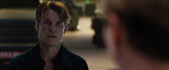 Movie still from “F9: The Fast Saga” (2021), directed by Justin Lin – A man with a beard is looking at the camera; Close Up shot, Over the shoulder angle