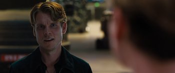 Movie still from “F9: The Fast Saga” (2021), directed by Justin Lin – A young man is smiling at the camera; Close Up shot, Over the shoulder angle