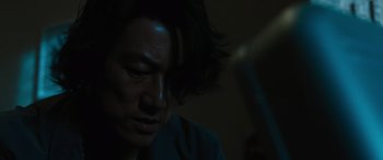 Movie still from “F9: The Fast Saga” (2021), directed by Justin Lin – A man with long black hair looking down at his face; Close Up shot, Low angle