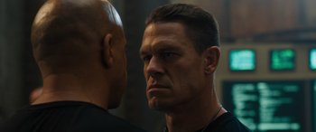 Movie still from “F9: The Fast Saga” (2021), directed by Justin Lin – A person looking at the camera; Close Up shot, Over the shoulder angle