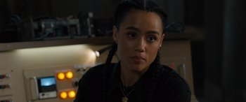Movie still from “F9: The Fast Saga” (2021), directed by Justin Lin – A woman with braids is looking at the camera; Close Up shot, Over the shoulder angle
