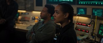 Movie still from “F9: The Fast Saga” (2021), directed by Justin Lin – A man and a woman sitting next to each other; Close Up shot, Over the shoulder angle