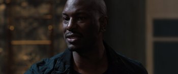 Movie still from “F9: The Fast Saga” (2021), directed by Justin Lin – A person wearing a black shirt; Close Up shot, Over the shoulder angle