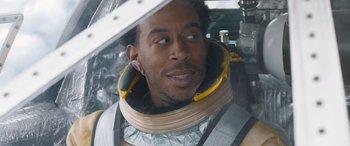 Movie still from “F9: The Fast Saga” (2021), directed by Justin Lin – A person wearing a space suit; Close Up shot, Over the shoulder angle