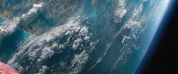 Movie still from “F9: The Fast Saga” (2021), directed by Justin Lin – An aerial view of a body of water with a plane flying overhead; Extreme Wide shot, Overhead angle