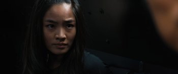 Movie still from “F9: The Fast Saga” (2021), directed by Justin Lin – A person with long black hair; Close Up shot, Low angle