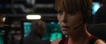 Movie still from “F9: The Fast Saga” (2021), directed by Justin Lin – A person with a headset on; Close Up shot, Over the shoulder angle