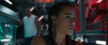 Movie still from “F9: The Fast Saga” (2021), directed by Justin Lin – A woman with a black shirt is wearing a black shirt; Close Up shot, Low angle