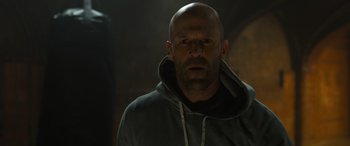 Movie still from “F9: The Fast Saga” (2021), directed by Justin Lin – A man with a beard and a hooded sweatshirt; Close Up shot, Low angle