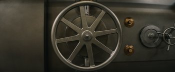 A large metal wheel in a room