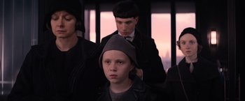 Movie still from “Fantastic Beasts and Where to Find Them” (2016), directed by David Yates – A young boy getting his hair cut on a train; Close Up shot, Over the shoulder angle