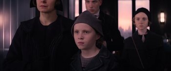 Movie still from “Fantastic Beasts and Where to Find Them” (2016), directed by David Yates – A young boy wearing a gray hat and a black jacket; Close Up shot, High angle
