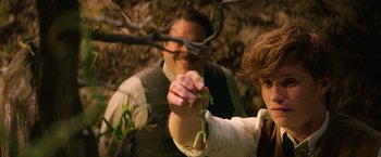 Movie still from “Fantastic Beasts and Where to Find Them” (2016), directed by David Yates – A man and a woman holding a plant in their hands; Close Up shot, Over the shoulder angle