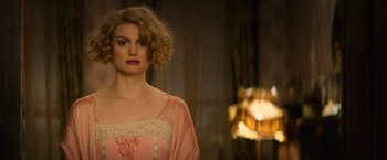 Movie still from “Fantastic Beasts and Where to Find Them” (2016), directed by David Yates – A woman in a pink dress and a pink robe; Close Up shot, Over the shoulder angle