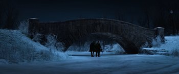 Movie still from “Fantastic Beasts and Where to Find Them” (2016), directed by David Yates – A couple of people standing under a bridge at night; Extreme Wide shot, High angle