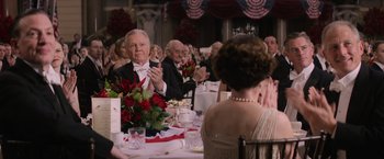 Movie still from “Fantastic Beasts and Where to Find Them” (2016), directed by David Yates – A group of people sitting at a dinner table; Medium shot, Over the shoulder angle