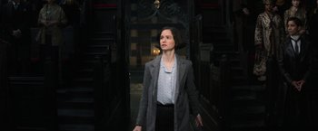 Movie still from “Fantastic Beasts and Where to Find Them” (2016), directed by David Yates – A woman standing in front of a church door; Medium shot, High angle